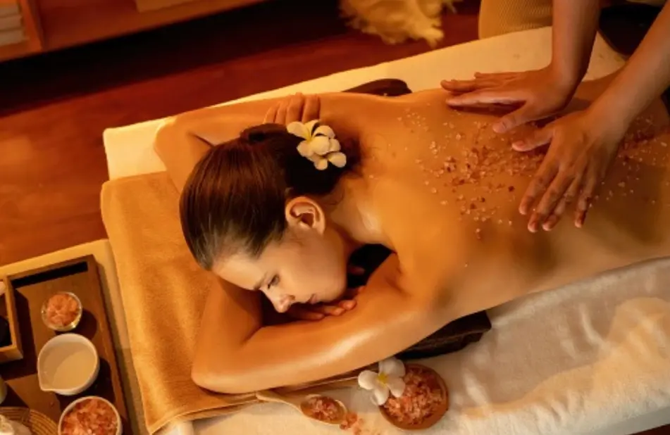 A woman laying on her stomach in the spa.